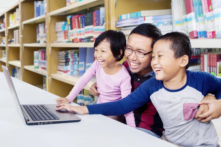 family using computer in library